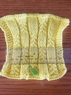 Gauge swatch before blocking, with the ribbing drawing in.