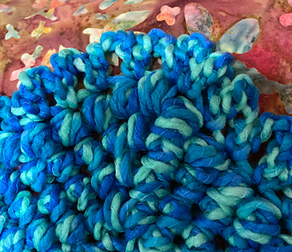 Thick puff stitches with a simple frilly border.
