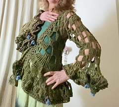 Frilly flare sleeve cuffs with floral embellishments and flower and loop button
fastening give this cardigan a true Boho feel.
