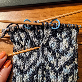 Needle points to the start of the thumb gusset.