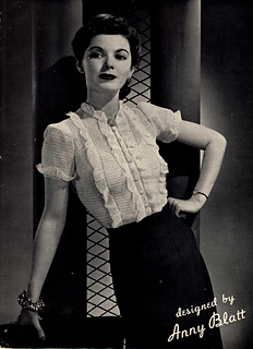 Anny Blatt ruffles crochet to create this demure blouse. For expert crocheters!