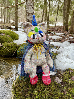 He has a crochet wizard hat, crochet cloak, and knit boots