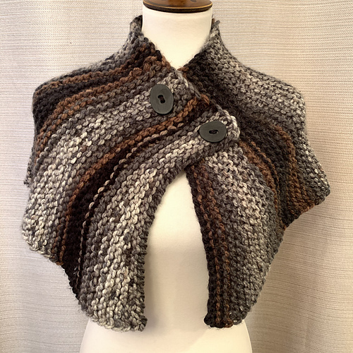 An asymmetric, buttoned capelet in bulky colorwork yarn