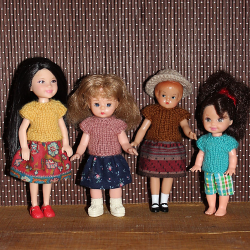 The tees fit well on the Kelly dolls.  They are a bit snug at the hem on the center two.  If I knit tees just for them, I will add another set of increases.