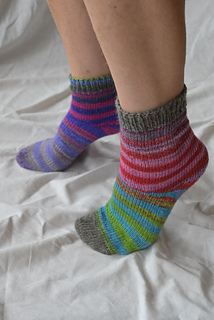 Comparison between the two pairs of socks - one pair is shorter and the other pair has contrast toes and cuffs.