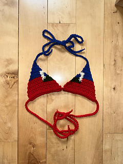 Haiti bikini top lies on a wooden surface
