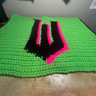 Finished tapestry lies flat on a desk