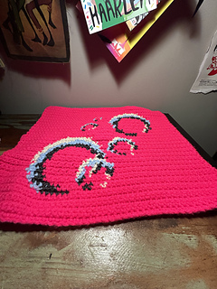 Tapestry lies flat on a desk