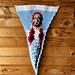 White and blue crochet pennant features image of Dorothy Gale