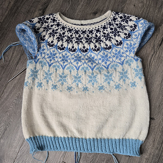 The light blue hem fits the look of the sweater better and the shaping is much better after re-knitting