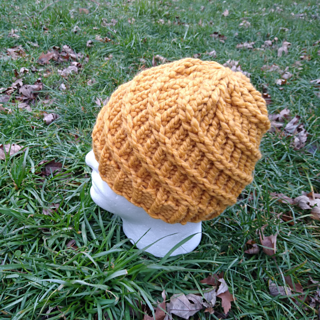 yellow beanie with protruding stitches that create a spiral