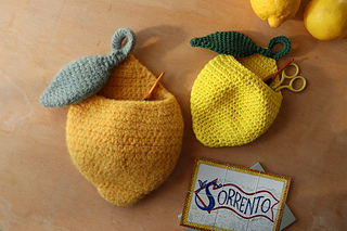 Limoncino Wall Baskets on a wooden background, with a postcard from Sorrento - an Italian town that inspired the design.