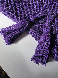 purple variegated hairpin and chain lace crocheted shawl with tassels in a silky yarn.