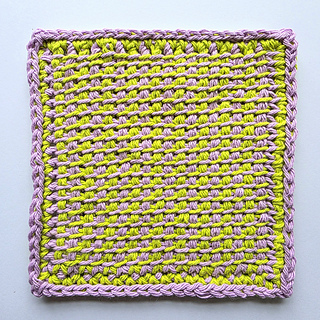 Tunisian crocheted square cloth with a lime and lavender pattern on a white background.