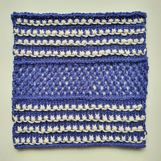 Blue and white knitted square with textures slip stitch and lace mesh design