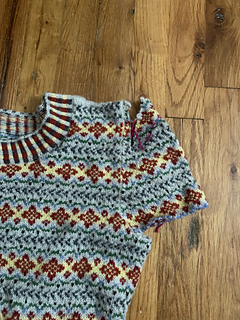 In the fitting session on Annie I cut the original sleeves a safe margin from the body, tucked them under the body, then used scrap yarn to baste an approximation of where the new sleeve cap should be.