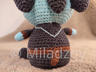 Thresh from League of Legends, crochet toy made by amigurumi technique.  Used dark grey, turqoise and brown yarn. Back and tail detail view.