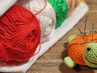 Required color palette, red, white, green, beige yarn skeins, pins, stitch markers.