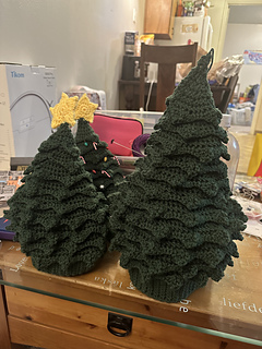 These are undecorated child and adult sized hats. The adult hat has a water bottle underneath to support it standing up