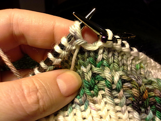 Slip both strands to the right needle.