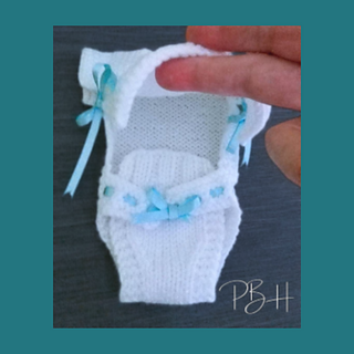 The Nappy section folds up for tieing round the waist. Top folds over Baby's Head