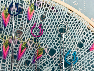 Stitch markers hold necklaces