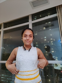 My thumbs show the difference in the armhole length before and after the edging when you see from the left to right