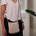 Crochet wool spiral crossbody bag with raffia trim