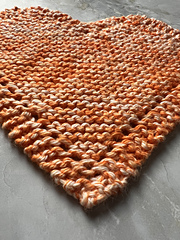 close up image of heart discloth showing 3 sis-garter border with eyelets running along the outer edge.