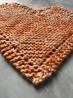 close up image of heart discloth showing 3 sis-garter border with eyelets running along the outer edge.