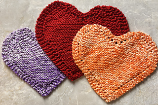 3 heart-shaped dishcloths in purple, orange and red.