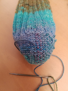 Reinforcing the toe, because my big toe nail is poking through the thin spots of this thick and thin yarn.