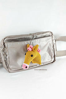 A mustard-colored with pink horse head keychain is unexpected, but amazing!