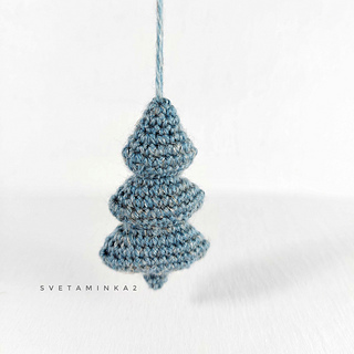 A hand-crocheted minimalist Christmas tree, a simple, elegant one-color amigurumi tree for a modern look, hanging, showcasing the result of the pattern.