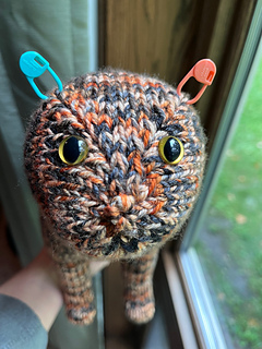 Showing where I placed markers for ears (stitch just above where the decreases started) and eyes. Stuff head, place eyes, pull stuffing out to lock them in place, then re-stuff.