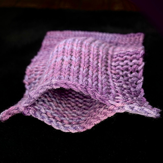 At the top edge looking down the tube. The bottom end of double knitting is always closed; only the top end is open.