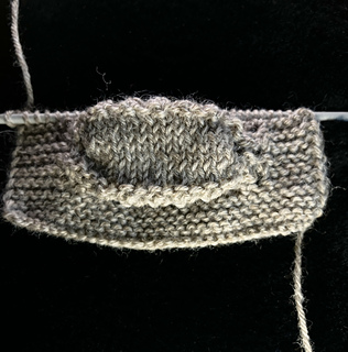Showing the first repeat with 9 stockinette rows between eyelet ridges