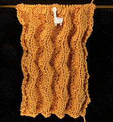 Before blocking, the stitch pattern looks like wavy ribbing.